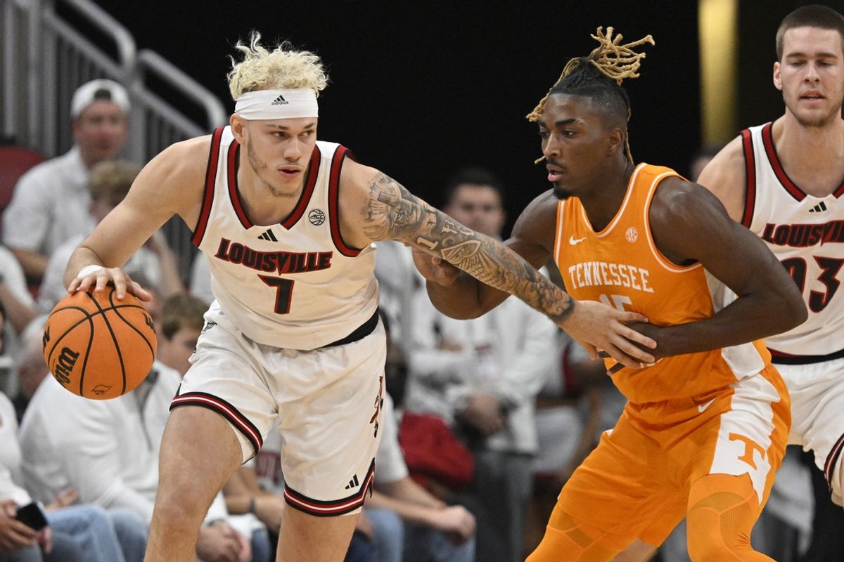 Nov 9, 2024; Louisville, Kentucky, USA;  Louisville Cardinals forward Kasean Pryor (7) dribbles against Tennessee Volunteers guard Jahmai Mashack (15) during the first half at KFC Yum! Center. Mandatory Credit: Jamie Rhodes-Imagn Images