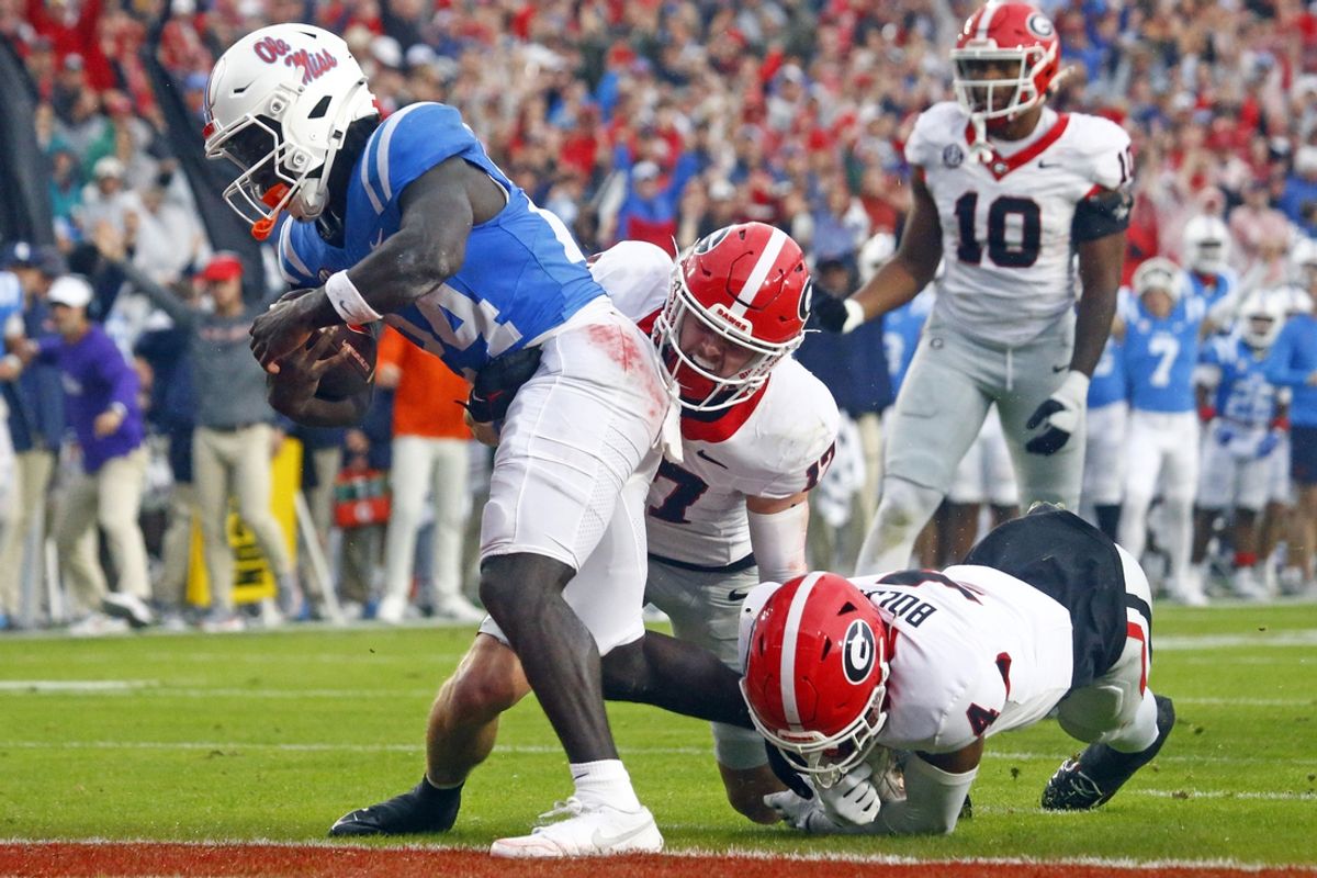 Nov 9, 2024; Oxford, Mississippi, USA; Mississippi Rebels running back Ulysses Bentley IV (24) runs the ball for a touchdown as Georgia Bulldogs defensive back Dan Jackson (17) and defensive back KJ Bolden (4) attempt to make the tackle during the first half at Vaught-Hemingway Stadium. Mandatory Credit: Petre Thomas-Imagn Images