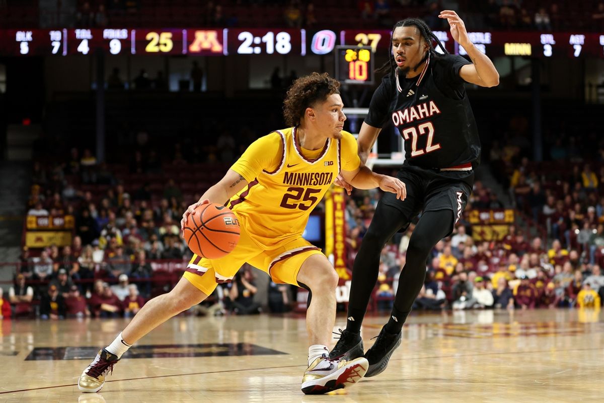 Nov 9, 2024; Minneapolis, Minnesota, USA; Minnesota Golden Gophers guard Lu'Cye Patterson (25) works past Omaha Mavericks forward Kamryn Thomas (22) during the first half at Williams Arena. Mandatory Credit: Matt Krohn-Imagn Images