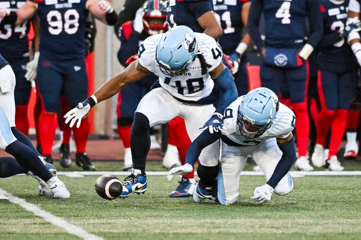 Nov 9, 2024; Montreal, Quebec, CAN; Toronto Argonauts line backer Wynton McManis (48) recovers a fumbled ball against the Montreal Alouettes during the second quarter at Percival-Molson Memorial Stadium. Mandatory Credit: David Kirouac-Imagn Images