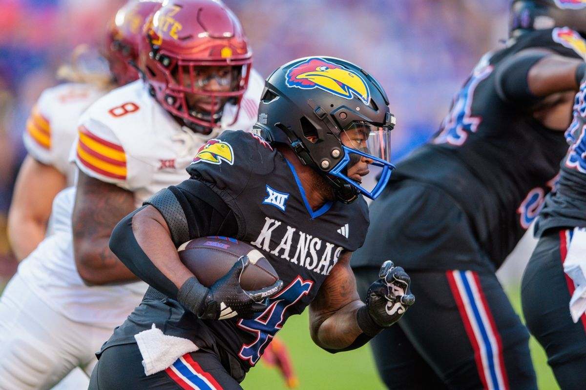 Nov 9, 2024; Kansas City, Missouri, USA; Kansas Jayhawks running back Devin Neal (4) runs the ball during the first quarter against the Iowa State Cyclones at GEHA Field at Arrowhead Stadium. Mandatory Credit: William Purnell-Imagn Images