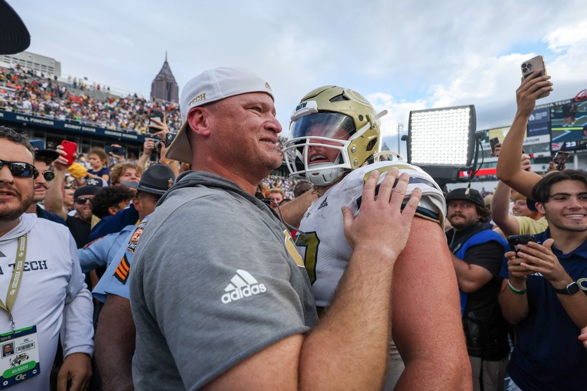 Nov 9, 2024; Atlanta, Georgia, USA; Georgia Tech Yellow Jackets head coach Brent Key hugs offensive lineman Weston Franklin (72) after a victory over the Miami Hurricanes at Bobby Dodd Stadium at Hyundai Field. Mandatory Credit: Brett Davis-Imagn Images