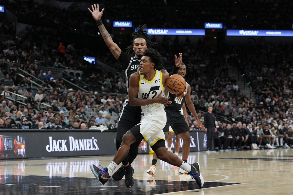 Nov 9, 2024; San Antonio, Texas, USA;  Utah Jazz guard Collin Sexton (2) drives in past San Antonio Spurs guard Stephon Castle (5) in the first half at Frost Bank Center. Mandatory Credit: Daniel Dunn-Imagn Images