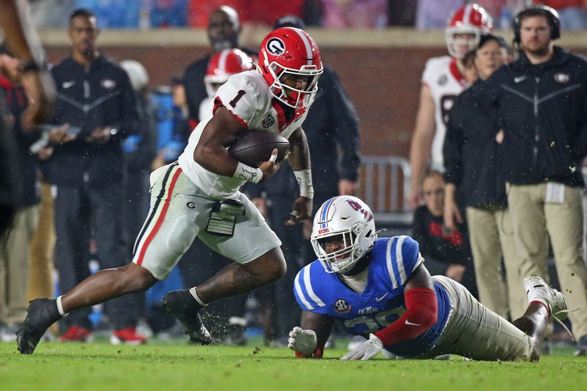 Nov 9, 2024; Oxford, Mississippi, USA; Georgia Bulldogs running back Trevor Etienne (1) runs the ball as he breaks a tackle attempt by Mississippi Rebels defensive JJ Pegues (38) during the second half at Vaught-Hemingway Stadium. Mandatory Credit: Petre Thomas-Imagn Images