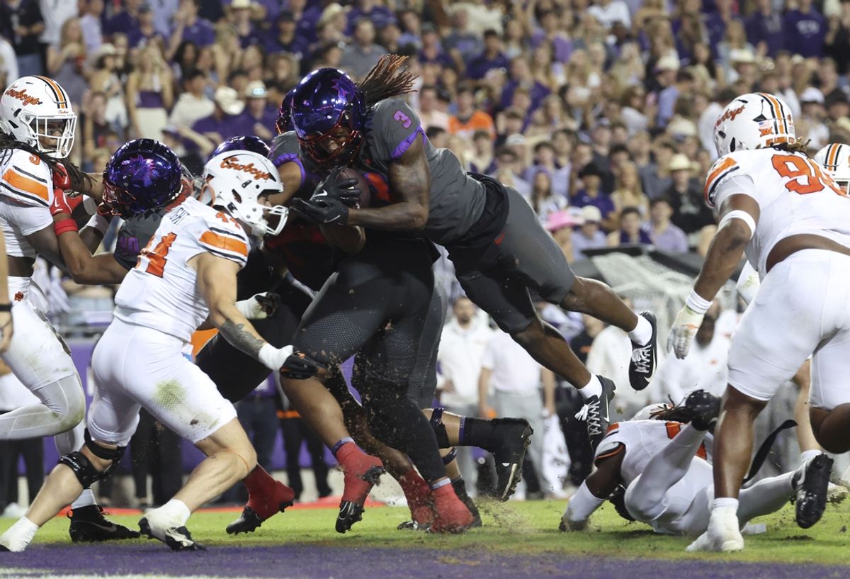 Nov 9, 2024; Fort Worth, Texas, USA;  TCU Horned Frogs wide receiver Savion Williams (3) dives for a touchdown as Oklahoma State Cowboys linebacker Justin Wright (44) defends during the second quarter at Amon G. Carter Stadium. Mandatory Credit: Kevin Jairaj-Imagn Images