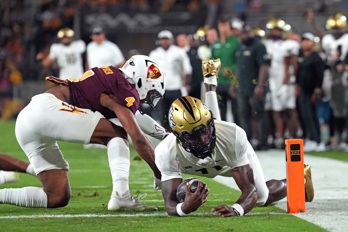 Nov 9, 2024; Tempe, Arizona, USA; UCF Knights quarterback Jacurri Brown (11) dives for a touchdown against the Arizona State Sun Devils during the first half at Mountain America Stadium, Home of the ASU Sun Devils. Mandatory Credit: Joe Camporeale-Imagn Images