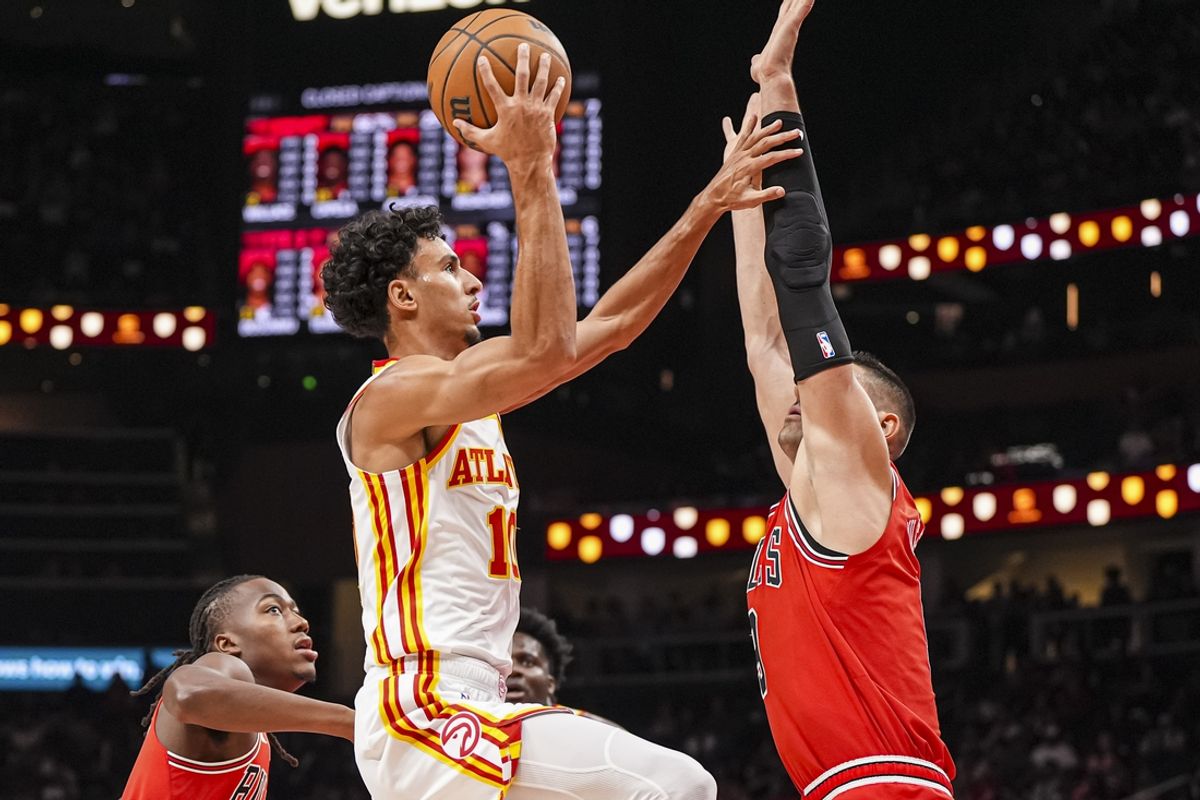 Nov 9, 2024; Atlanta, Georgia, USA; Atlanta Hawks forward Zaccharie Risacher (10) shoots against Chicago Bulls center Nikola Vucevic (9) during the first half at State Farm Arena. Mandatory Credit: Dale Zanine-Imagn Images