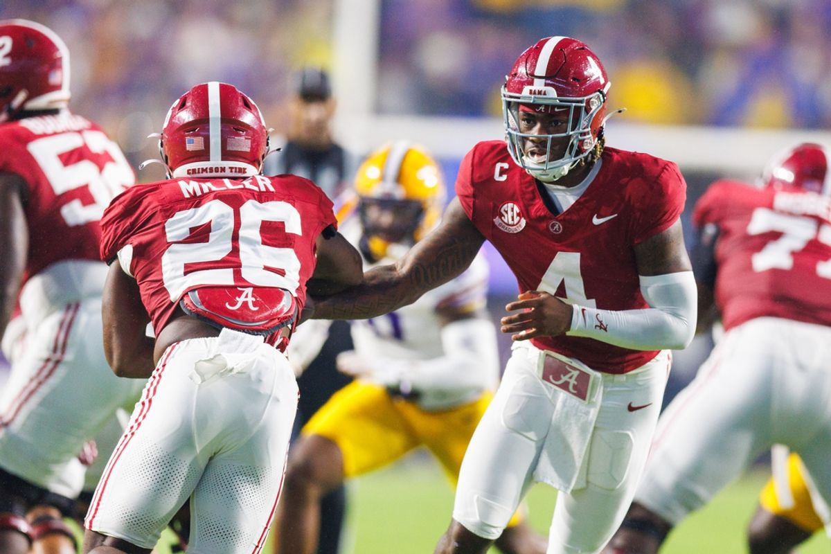 Nov 9, 2024; Baton Rouge, Louisiana, USA;  Alabama Crimson Tide quarterback Jalen Milroe (4) hands the ball off to Alabama Crimson Tide running back Jam Miller (26) against the LSU Tigers at Tiger Stadium. Mandatory Credit: Stephen Lew-Imagn Images