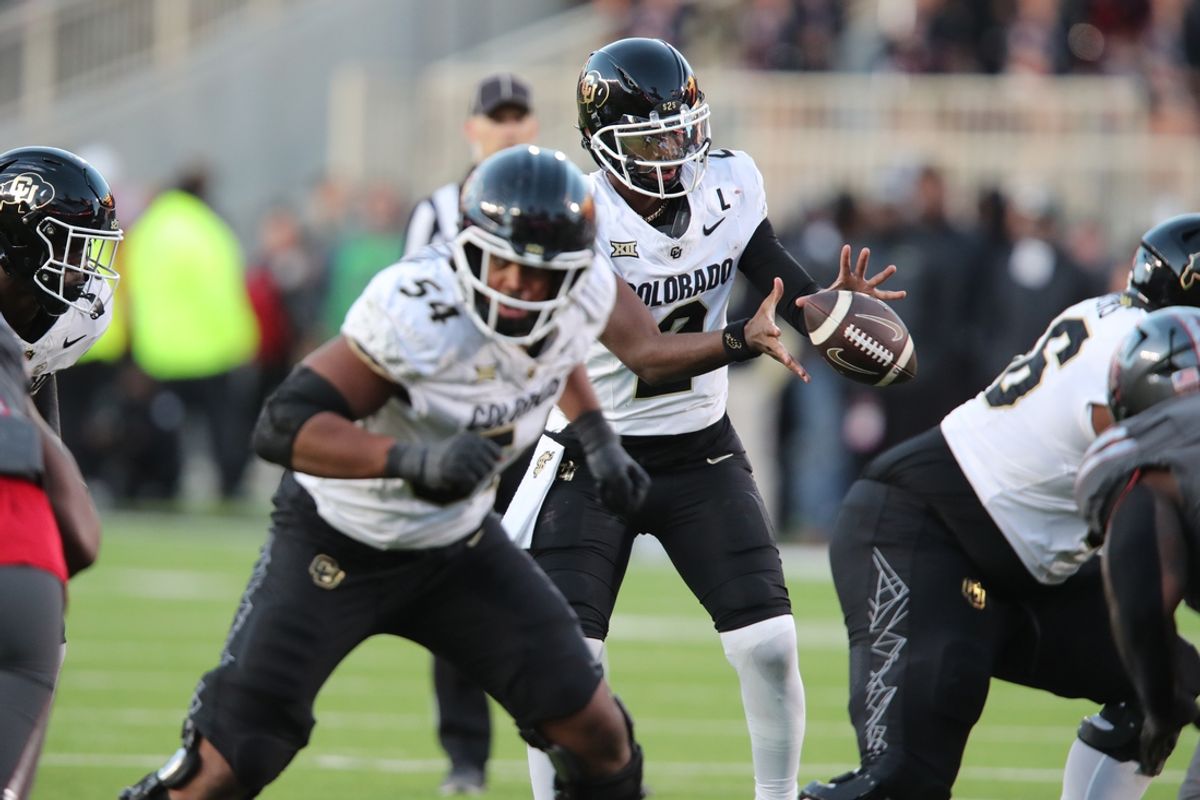 Nov 9, 2024; Lubbock, Texas, USA; Colorado Buffalos quarterback Shedeur Sanders (2) takes a snap in the second half against the Texas Tech Red Raiders at Jones AT&T Stadium and Cody Campbell Field. Mandatory Credit: Michael C. Johnson-Imagn Images