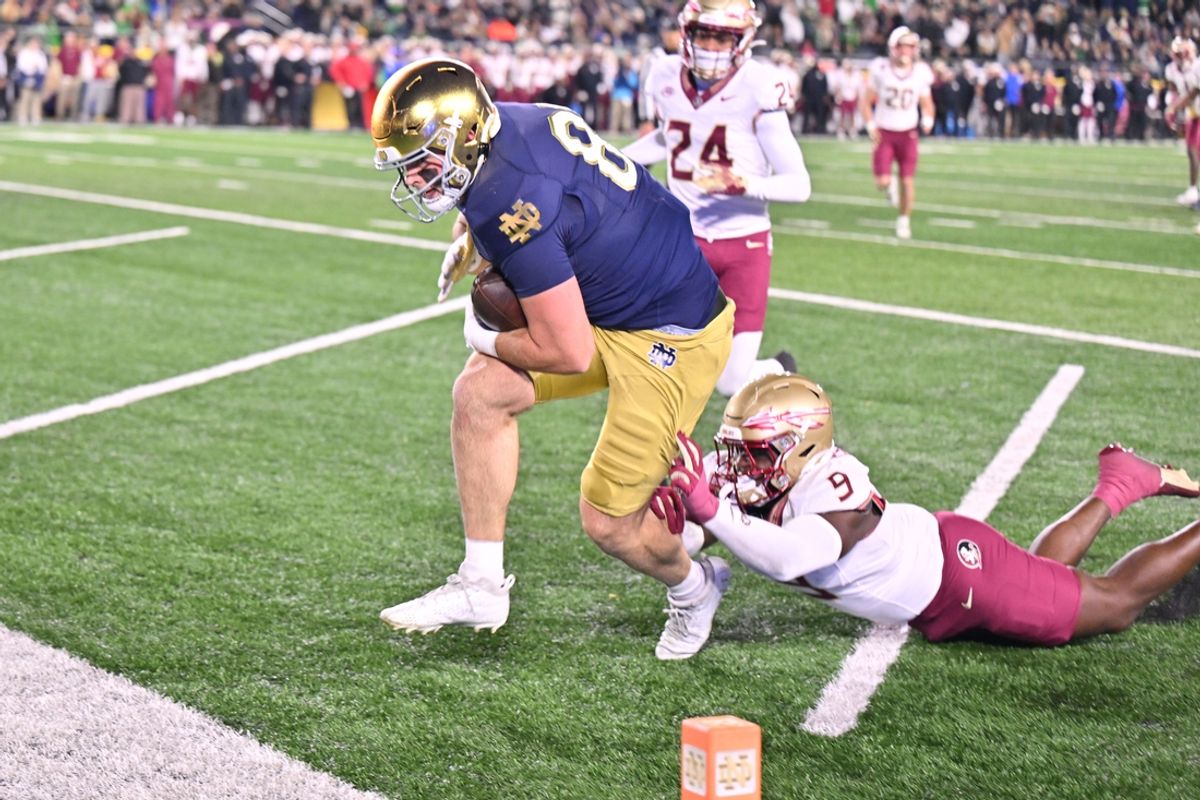 Nov 9, 2024; South Bend, Indiana, USA; Notre Dame Fighting Irish tight end Mitchell Evans (88) scores a touchdown against Florida State Seminoles linebacker Omar Graham Jr. (9) in the second quarter at Notre Dame Stadium. Mandatory Credit: Matt Cashore-Imagn Images