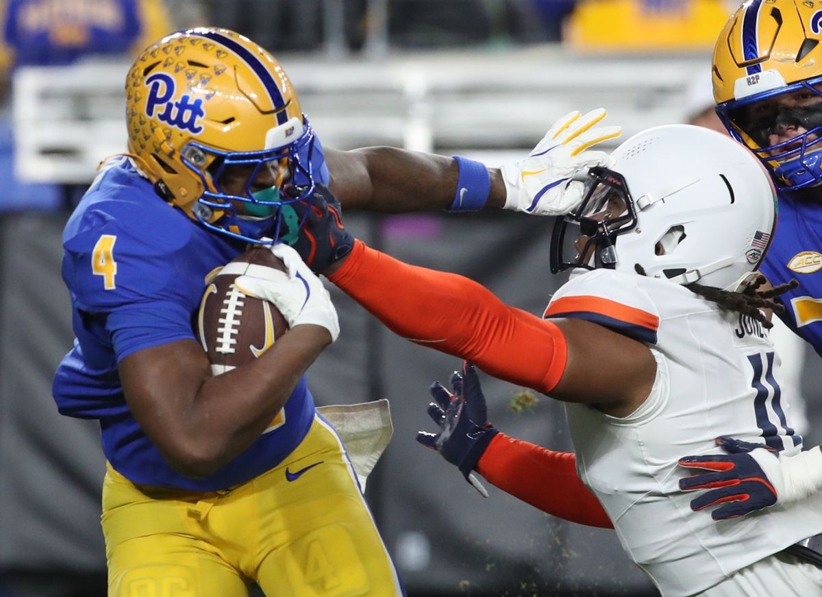 Nov 9, 2024; Pittsburgh, Pennsylvania, USA;  Pittsburgh Panthers running back Daniel Carter (4) carries the ball against Virginia Cavaliers defensive end Mekhi Buchanan (11) during the second quarter at Acrisure Stadium. Mandatory Credit: Charles LeClaire-Imagn Images