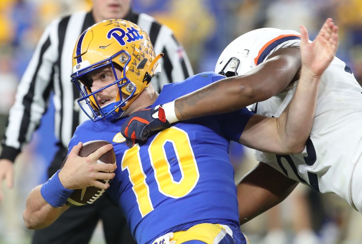 Nov 9, 2024; Pittsburgh, Pennsylvania, USA;  Pittsburgh Panthers quarterback Eli Holstein (10) is tackled by Virginia Cavaliers defensive tackle Terrell Jones (25) during the second quarter at Acrisure Stadium. Mandatory Credit: Charles LeClaire-Imagn Images