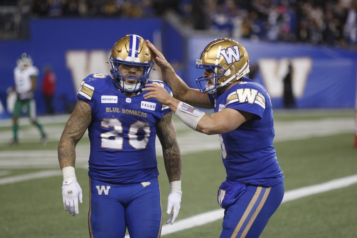 Nov 9, 2024; Winnipeg, Manitoba, CAN;  Winnipeg Blue Bombers running back Brady Oliveira (20) celebrates with quarterback Zach Collaros (8) after scoring a touchdown against the Saskatchewan Roughriders during the second half at PRINCESS AUTO STADIUM. Winnipeg won 38-22. Mandatory Credit: Bruce Fedyck-Imagn Images