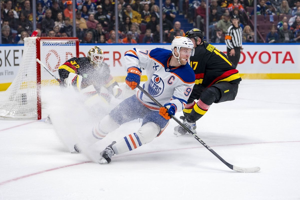 Nov 9, 2024; Vancouver, British Columbia, CAN; Edmonton Oilers forward Connor McDavid (97) handles the puck against the Vancouver Canucks during the first period at Rogers Arena. Mandatory Credit: Bob Frid-Imagn Images