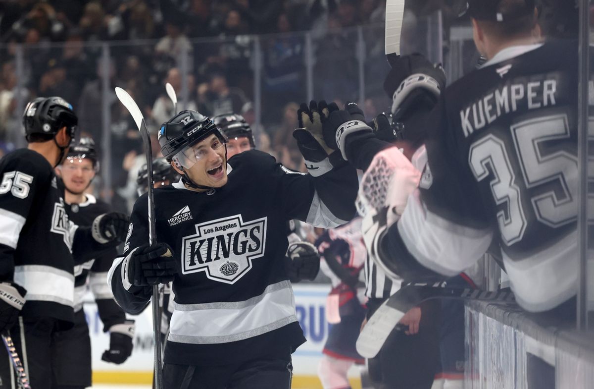 Nov 9, 2024; Los Angeles, California, USA; Los Angeles Kings left wing Trevor Moore (12) celebrates with teammates after scoring during the third period against the Columbus Blue Jackets at Crypto.com Arena. Mandatory Credit: Jason Parkhurst-Imagn Images