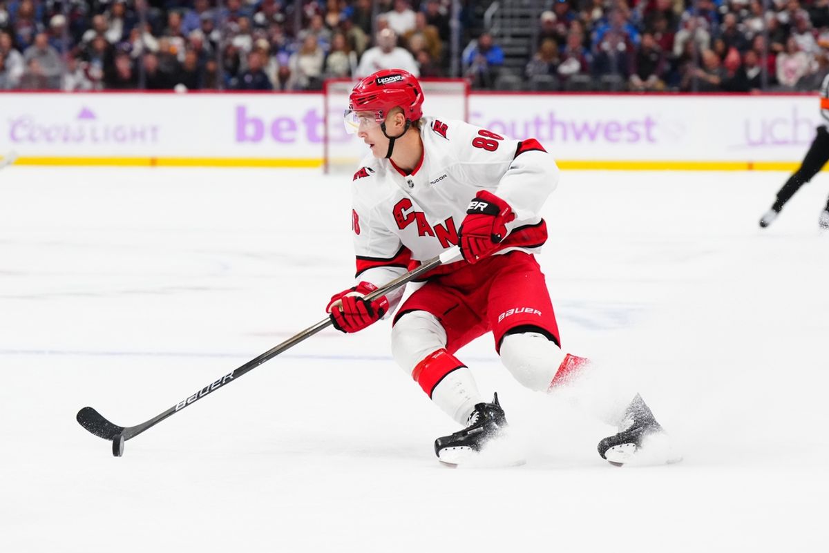 Nov 9, 2024; Denver, Colorado, USA; Carolina Hurricanes center Martin Necas (88) controls the puck in the third period against the Colorado Avalanche at Ball Arena. Mandatory Credit: Ron Chenoy-Imagn Images