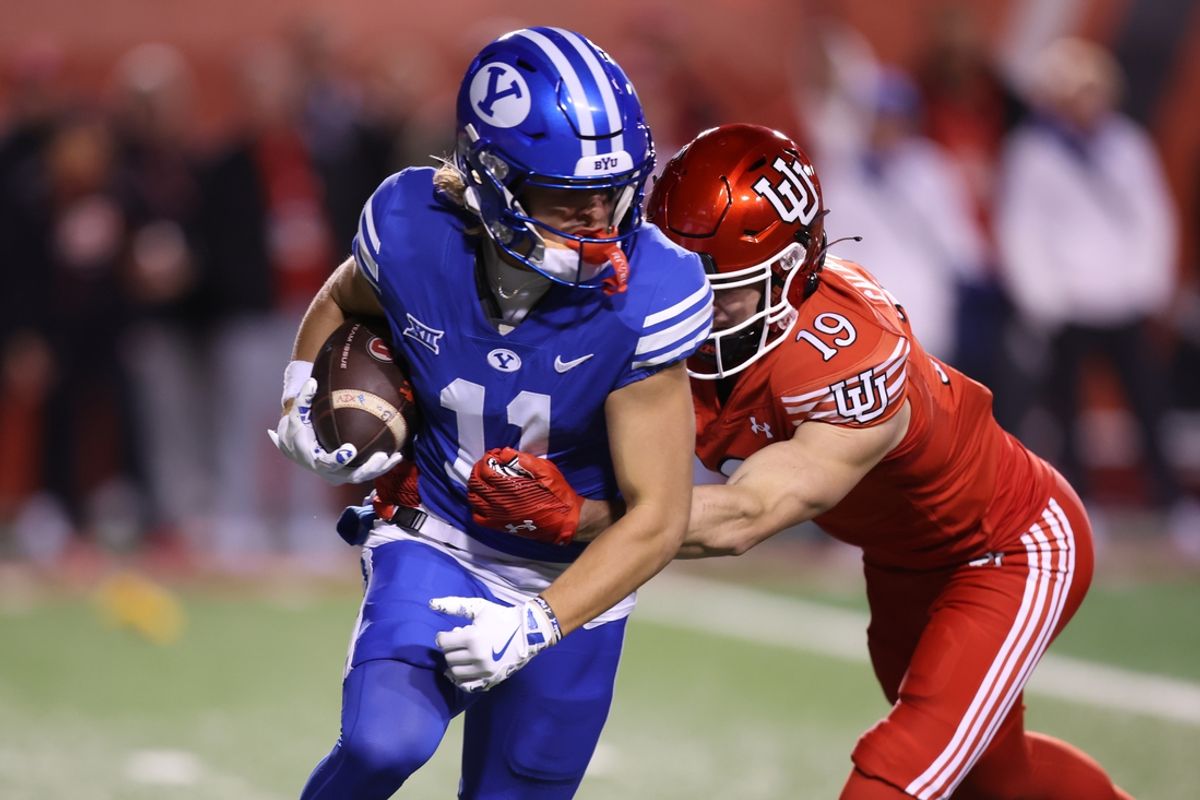Nov 9, 2024; Salt Lake City, Utah, USA; Brigham Young Cougars wide receiver Parker Kingston (11) returns a punt against Utah Utes wide receiver Luca Caldarella (19) during the second half at Rice-Eccles Stadium. Mandatory Credit: Rob Gray-Imagn Images