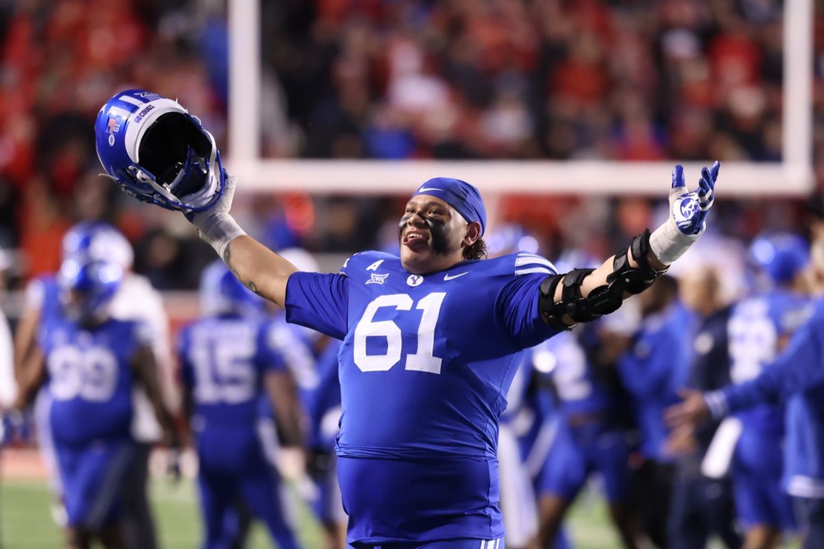Nov 9, 2024; Salt Lake City, Utah, USA; Brigham Young Cougars offensive lineman Weylin Lapuaho (61) celebrates after defeating the Utah Utes at Rice-Eccles Stadium. Mandatory Credit: Rob Gray-Imagn Images
