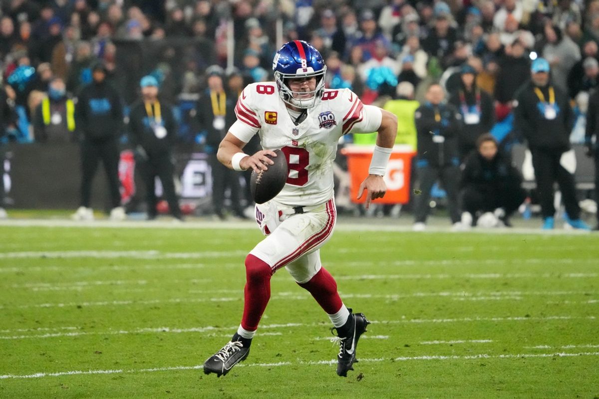 Nov 10, 2024; Munich, Germany; New York Giants quarterback Daniel Jones (8) carries the ball against the New York Giants in the second half during the 2024 NFL Munich Game at Allianz Arena. Mandatory Credit: Kirby Lee-Imagn Images