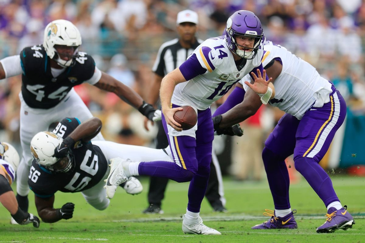 Minnesota Vikings quarterback Sam Darnold (14) is pressured by Jacksonville Jaguars linebacker Yasir Abdullah (56) during the second quarter an NFL football matchup Sunday, Nov. 10, 2024 at Everbank Stadium in Jacksonville, Fla. [Corey Perrine/Florida Times-Union]