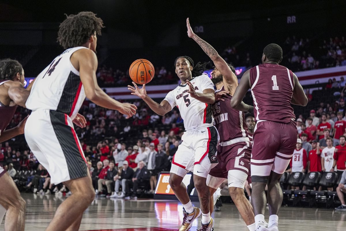 Nov 10, 2024; Athens, Georgia, USA; Georgia Bulldogs guard Silas Demary Jr. (5) passes the ball to forward Asa Newell (14) against Texas Southern Tigers forward Grayson Carter (25) during the first half at Stegeman Coliseum. Mandatory Credit: Dale Zanine-Imagn Images