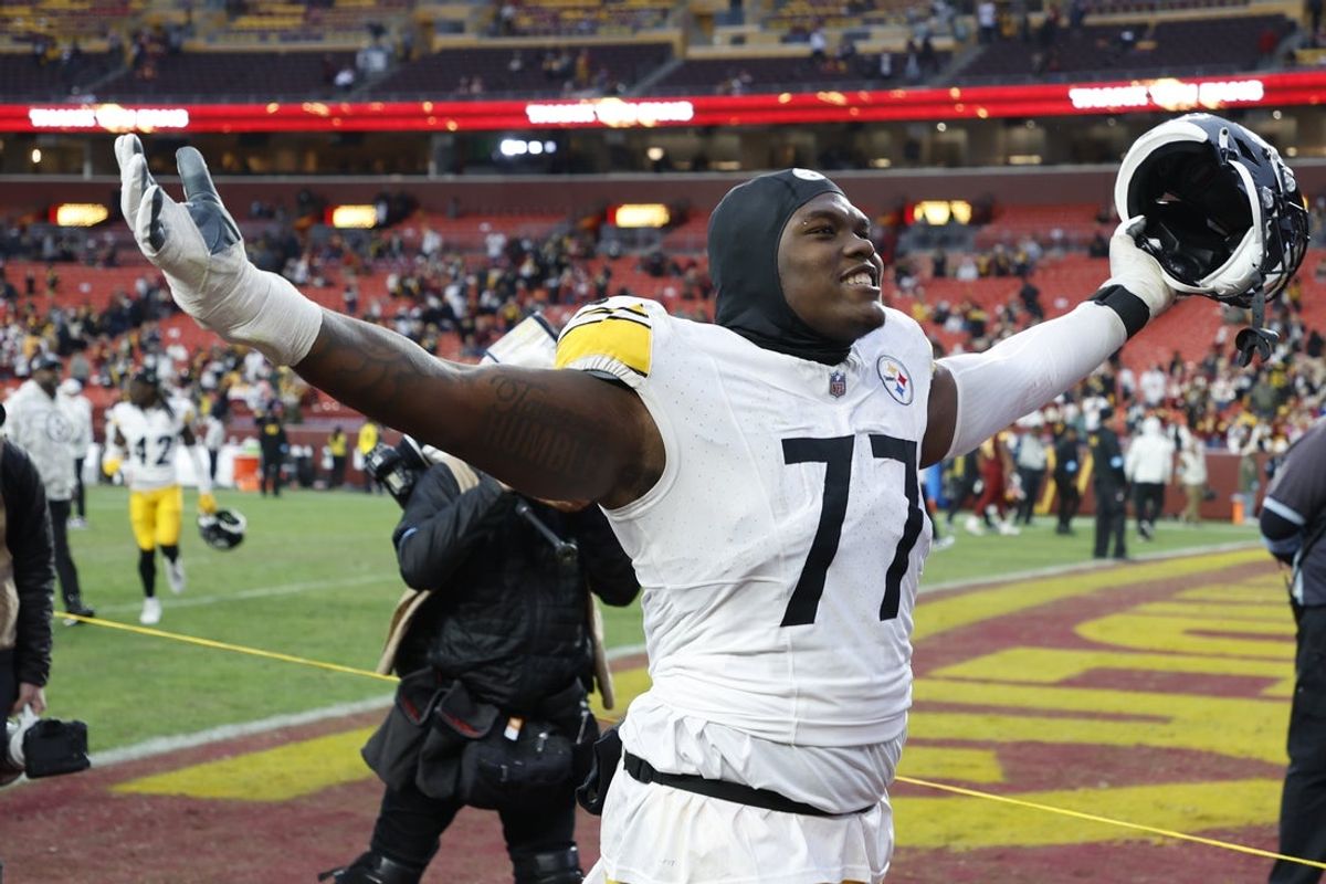 Nov 10, 2024; Landover, Maryland, USA; Pittsburgh Steelers offensive tackle Broderick Jones (77) celebrates while leaving the field after the Steelers' game against the Washington Commanders at Northwest Stadium. Mandatory Credit: Geoff Burke-Imagn Images