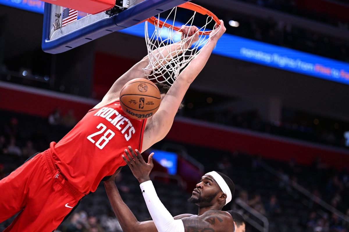 Nov 10, 2024; Detroit, Michigan, USA;  Houston Rockets center Alperen Sengun (28) dunks the ball on Detroit Pistons forward Paul Reed (7) in the second quarter at Little Caesars Arena. Mandatory Credit: Lon Horwedel-Imagn Images