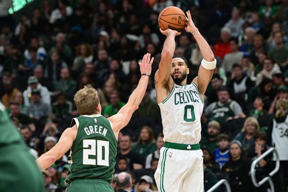 Nov 10, 2024; Milwaukee, Wisconsin, USA;  Boston Celtics forward Jayson Tatum (0) takes a shot against Milwaukee Bucks guard AJ Green (20) in the fourth quarter at Fiserv Forum. Mandatory Credit: Benny Sieu-Imagn Images