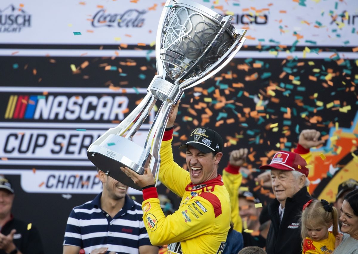 Nov 10, 2024; Avondale, Arizona, USA; NASCAR Cup Series driver Joey Logano (22) celebrates after winning the 2024 NASCAR Cup Series championship and the NASCAR Cup Series Championship race at Phoenix Raceway. Mandatory Credit: Mark J. Rebilas-Imagn Images