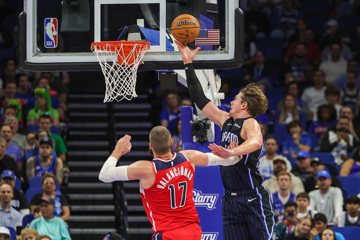 Nov 10, 2024; Orlando, Florida, USA; Orlando Magic center Moritz Wagner (21) goes to the basket against Washington Wizards center Jonas Valanciunas (17) during the second quarter at Kia Center. Mandatory Credit: Mike Watters-Imagn Images