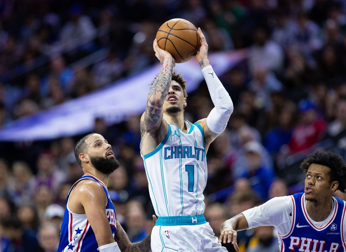 Nov 10, 2024; Philadelphia, Pennsylvania, USA; Charlotte Hornets guard LaMelo Ball (1) drives for a shot between Philadelphia 76ers forward Caleb Martin (L) and guard Jeff Dowtin Jr. (R) during the second quarter at Wells Fargo Center. Mandatory Credit: Bill Streicher-Imagn Images