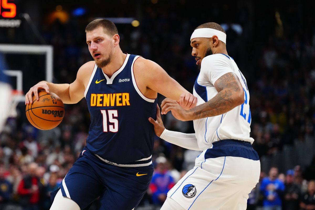 Nov 10, 2024; Denver, Colorado, USA; Dallas Mavericks center Daniel Gafford (21) defends on Denver Nuggets center Nikola Jokic (15) in the first quarter at Ball Arena. Mandatory Credit: Ron Chenoy-Imagn Images