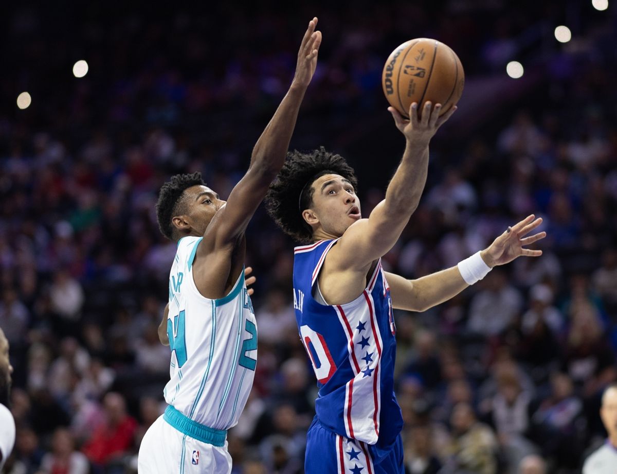 Nov 10, 2024; Philadelphia, Pennsylvania, USA; Philadelphia 76ers guard Jared McCain (20) drives for a shot past Charlotte Hornets forward Brandon Miller (24) during the third quarter at Wells Fargo Center. Mandatory Credit: Bill Streicher-Imagn Images