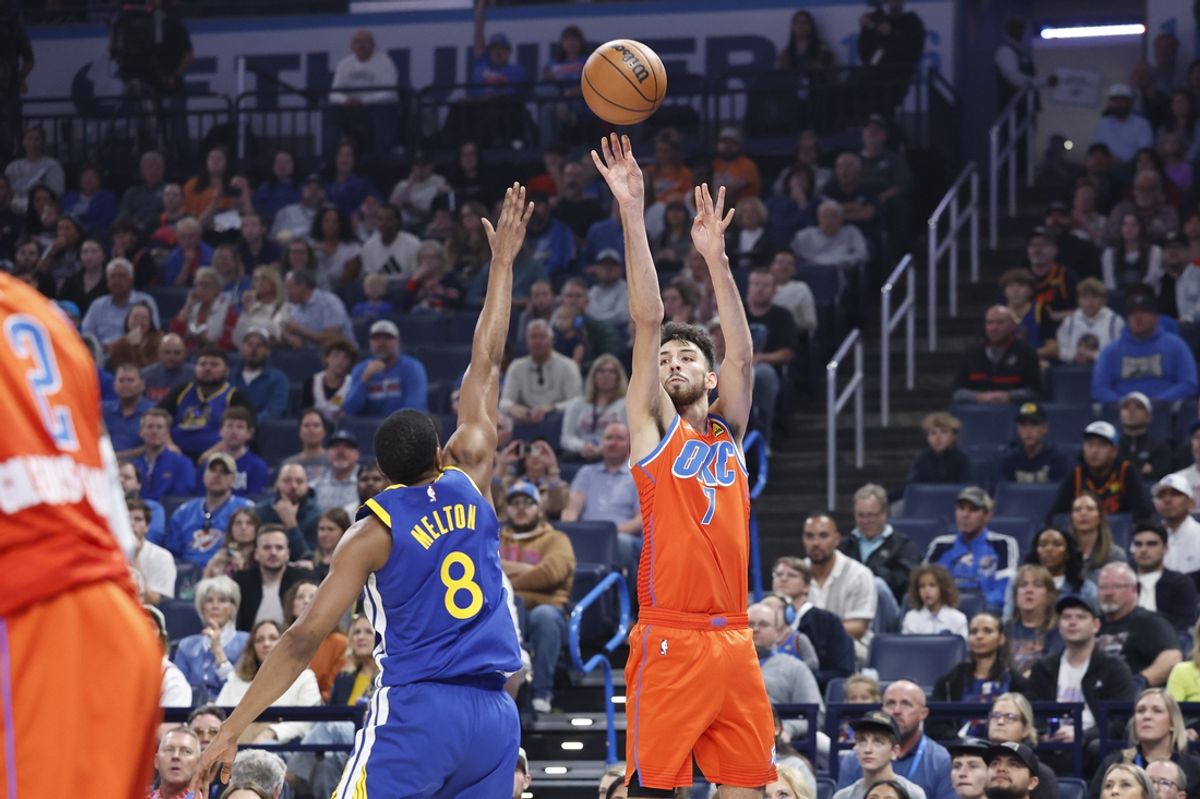 Nov 10, 2024; Oklahoma City, Oklahoma, USA; Oklahoma City Thunder forward Chet Holmgren (7) shoots a three point basket over Golden State Warriors guard De'Anthony Melton (8) during the first quarter at Paycom Center. Mandatory Credit: Alonzo Adams-Imagn Images