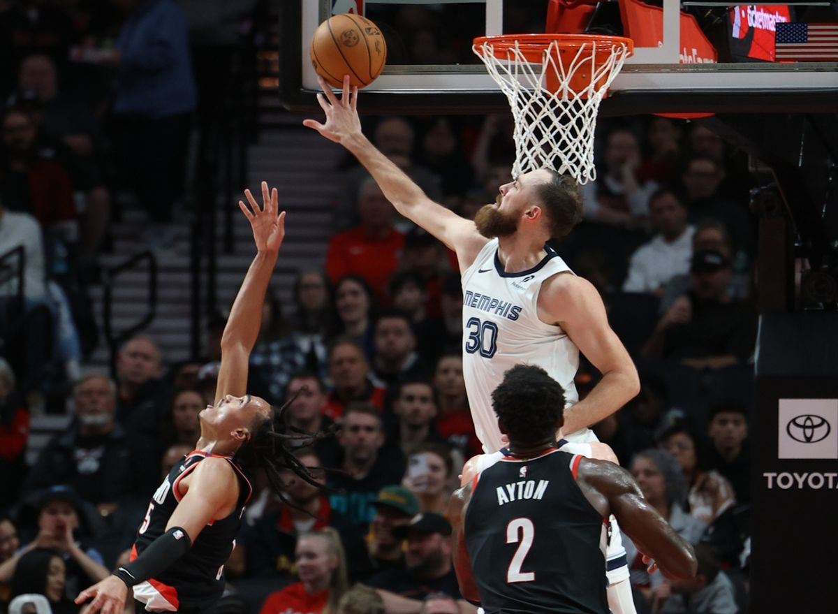 Nov 10, 2024; Portland, Oregon, USA;  Memphis Grizzlies center Jay Huff (30) blocks Portland Trail Blazers guard Dalano Barton (5) in the first half at Moda Center. Mandatory Credit: Jaime Valdez-Imagn Images