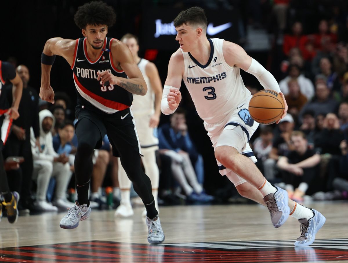 Nov 10, 2024; Portland, Oregon, USA; Memphis Grizzlies forward Jake LaRavia (3) dribbles past Portland Trail Blazers forward Toumani Camara (33) in the first half at Moda Center. Mandatory Credit: Jaime Valdez-Imagn Images