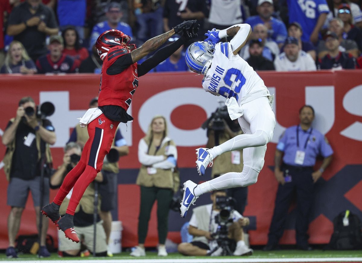 Nov 10, 2024; Houston, Texas, USA; Detroit Lions cornerback Carlton Davis III (23) intercepts a pass interned for Houston Texans wide receiver Tank Dell (3) during the third quarter at NRG Stadium. Mandatory Credit: Troy Taormina-Imagn Images