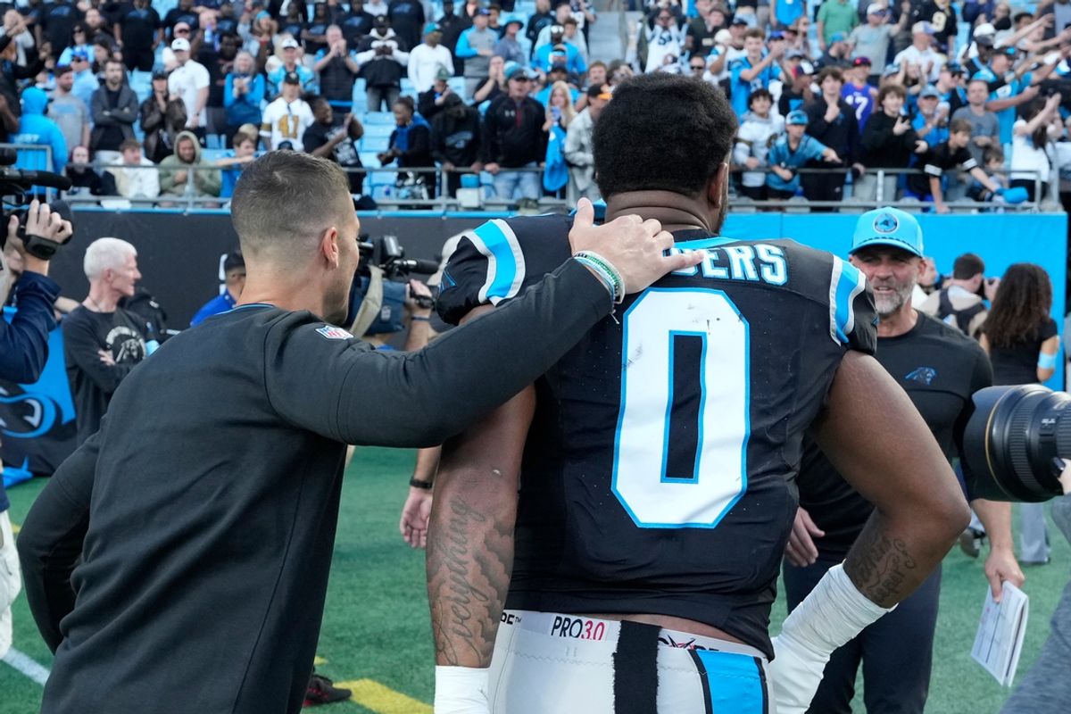 Nov 3, 2024; Charlotte, North Carolina, USA; Carolina Panthers head coach Dave Canales and tight end Ja'Tavion Sanders (0) leave the field after the game at Bank of America Stadium. Mandatory Credit: Bob Donnan-Imagn Images