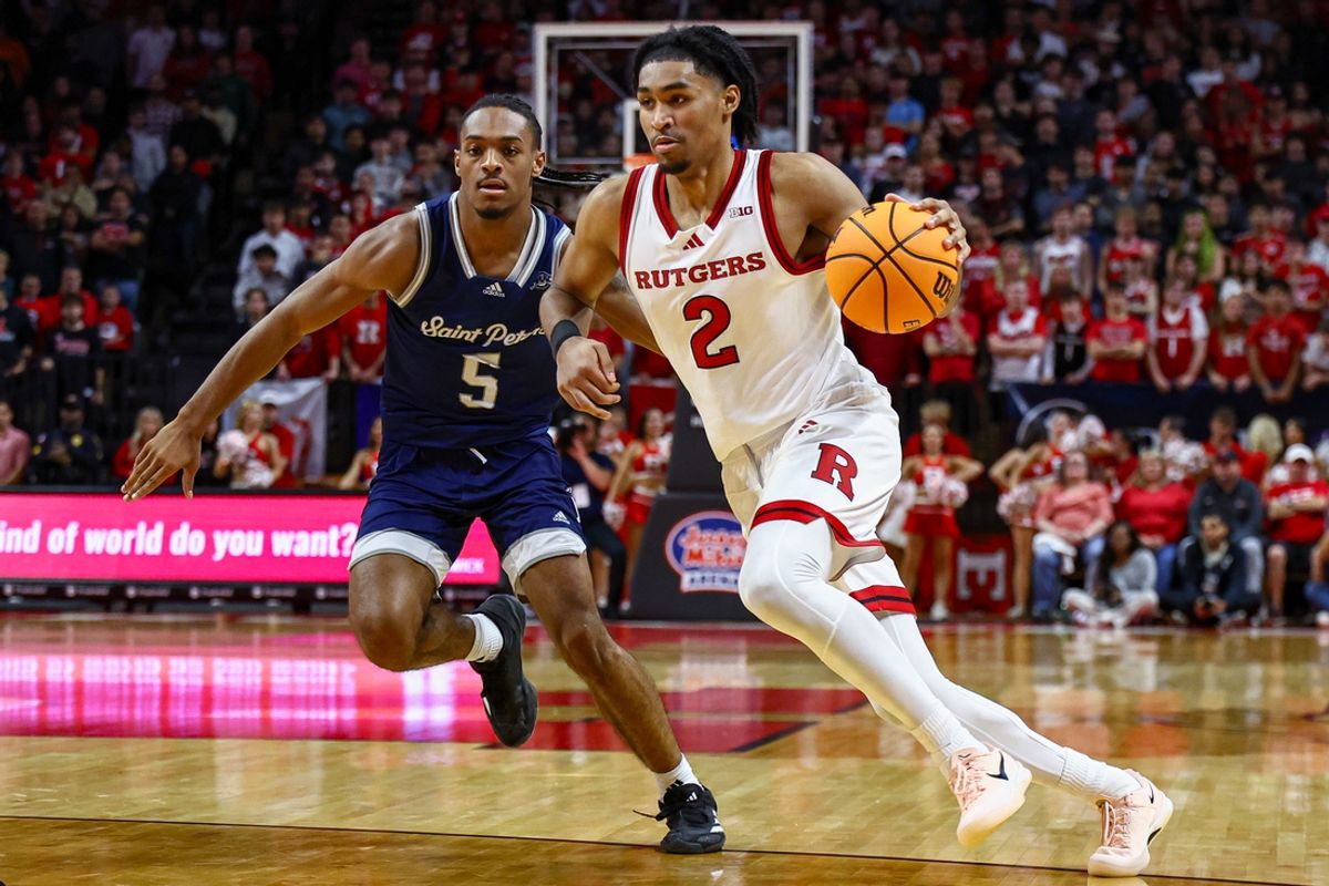 Nov 11, 2024; Piscataway, New Jersey, USA; Rutgers Scarlet Knights guard Dylan Harper (2) drives to the basket as St. Peter's Peacocks guard Armoni Zeigler (5) defends during the second half at Jersey Mike's Arena. Mandatory Credit: Vincent Carchietta-Imagn Images