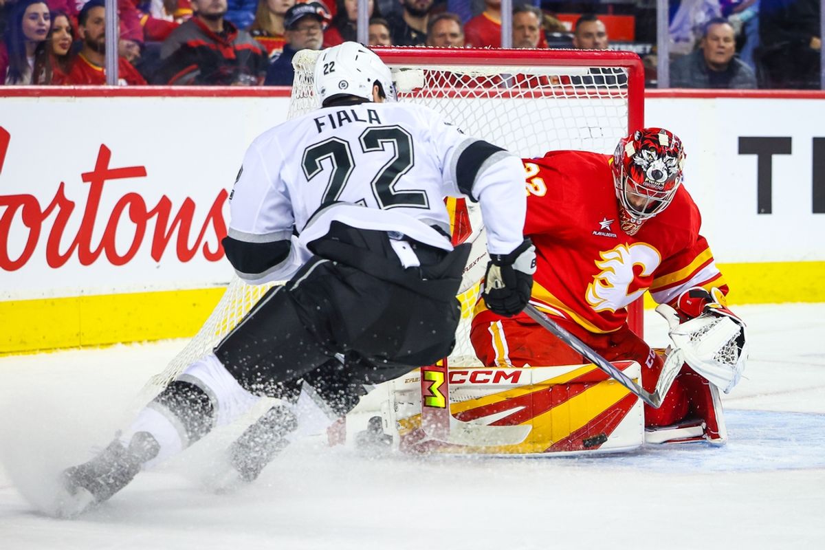 Nov 11, 2024; Calgary, Alberta, CAN; Calgary Flames goaltender Dustin Wolf (32) makes a save against Los Angeles Kings left wing Kevin Fiala (22) during the first period at Scotiabank Saddledome. Mandatory Credit: Sergei Belski-Imagn Images