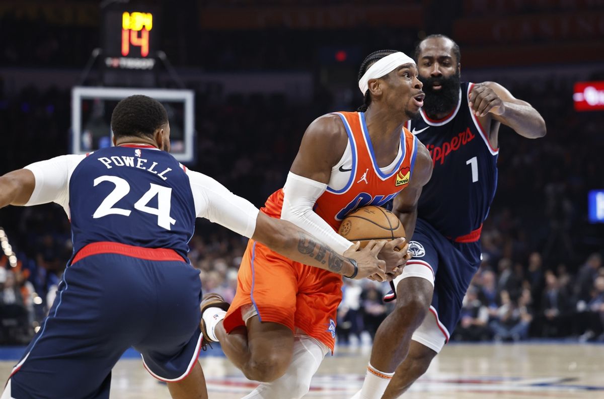 Nov 11, 2024; Oklahoma City, Oklahoma, USA; Oklahoma City Thunder guard Shai Gilgeous-Alexander (2) drives to the basket between Los Angeles Clippers guards Norman Powell (24) and James Harden (1) during the second quarter at Paycom Center. Mandatory Credit: Alonzo Adams-Imagn Images