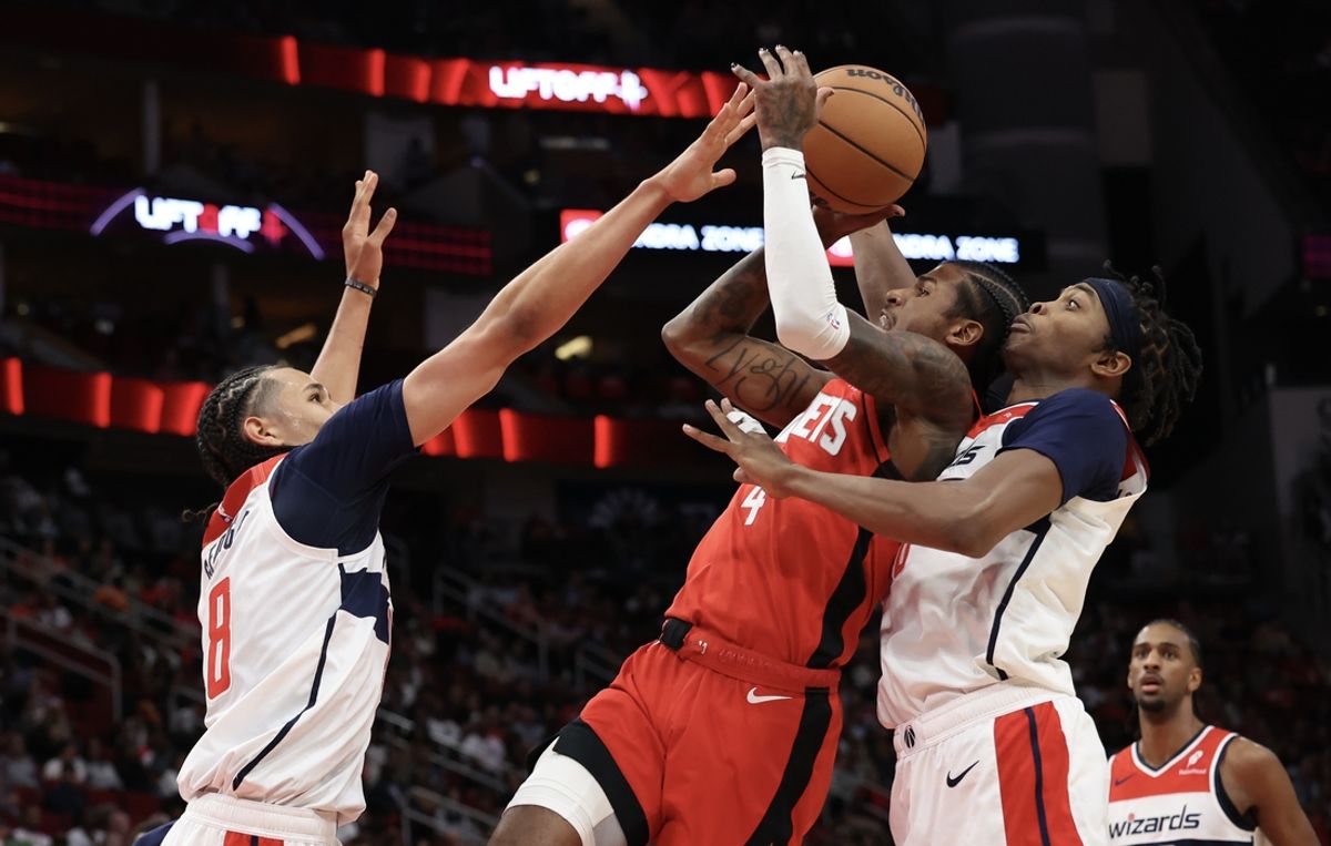 Nov 11, 2024; Houston, Texas, USA;  Houston Rockets guard Jalen Green (4) shoots against Washington Wizards guard Carlton Carrington (8) in the second quarter at Toyota Center. Mandatory Credit: Thomas Shea-Imagn Images