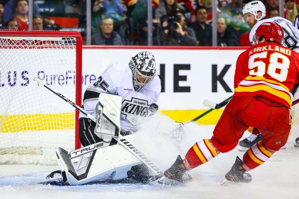 Nov 11, 2024; Calgary, Alberta, CAN; Los Angeles Kings goaltender Darcy Kuemper (35) makes a save against Calgary Flames center Justin Kirkland (58) during the second period at Scotiabank Saddledome. Mandatory Credit: Sergei Belski-Imagn Images