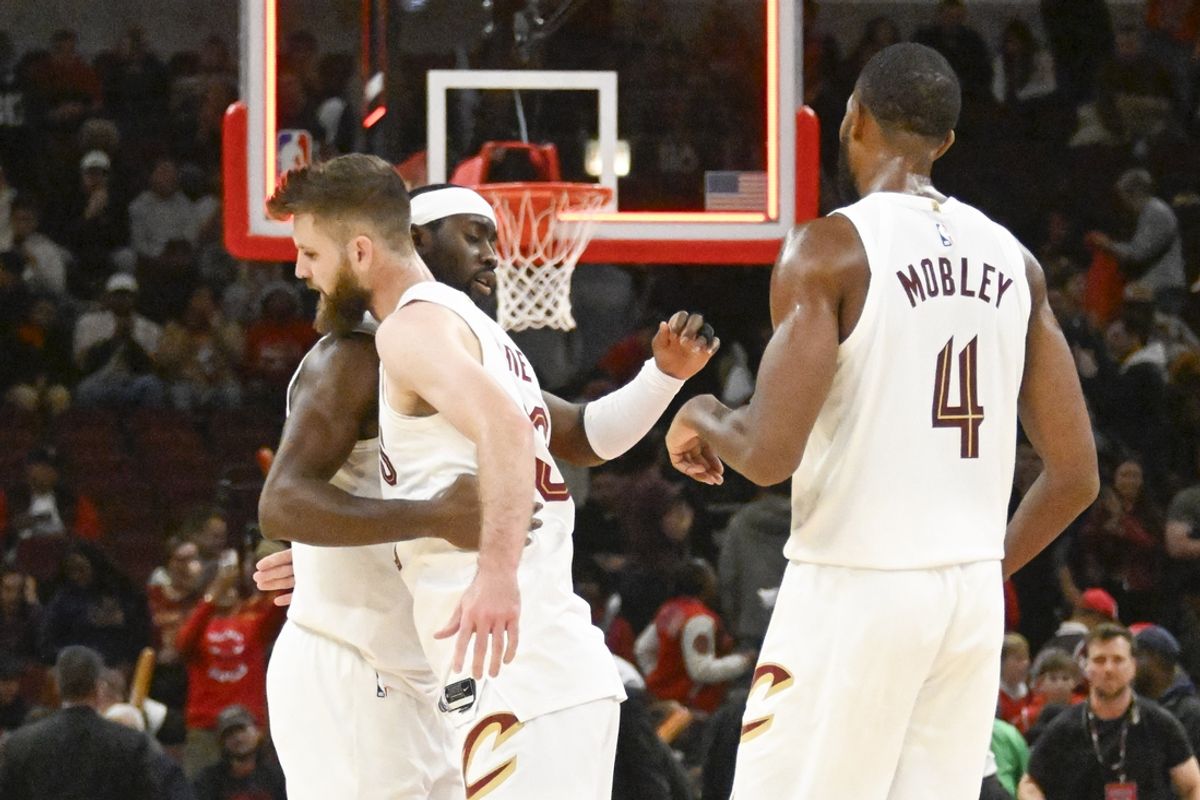 Nov 11, 2024; Chicago, Illinois, USA;  Cleveland Cavaliers guard Caris LeVert (3) hugs forward Dean Wade (32) and high fives  forward Evan Mobley (4) after the game against the Chicago Bulls  at United Center. Mandatory Credit: Matt Marton-Imagn Images