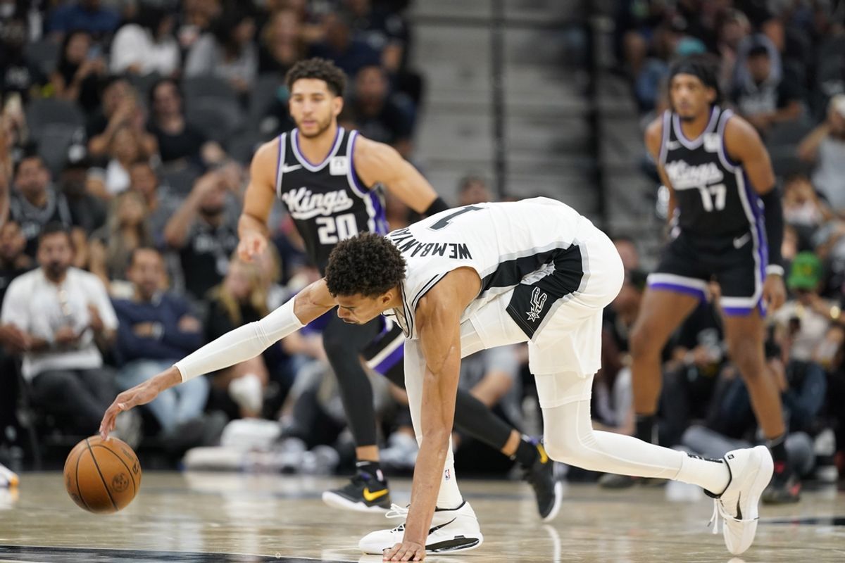 Nov 11, 2024; San Antonio, Texas, USA; San Antonio Spurs center Victor Wembanyama (1) reaches for a loose ball during the second half of the game against the Sacramento Kings at Frost Bank Center. Mandatory Credit: Scott Wachter-Imagn Images