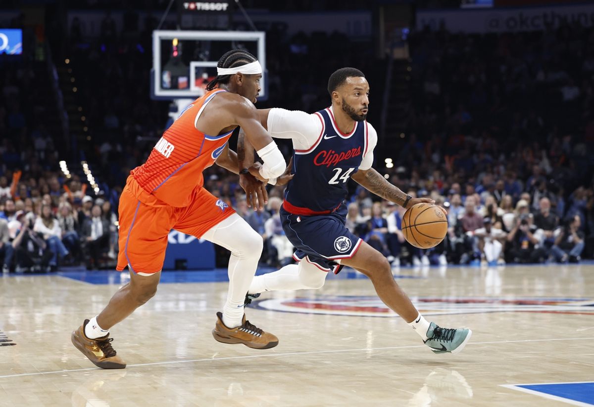 Nov 11, 2024; Oklahoma City, Oklahoma, USA; Los Angeles Clippers guard Norman Powell (24) drives around Oklahoma City Thunder guard Shai Gilgeous-Alexander (2) during the fourth quarter at Paycom Center. Mandatory Credit: Alonzo Adams-Imagn Images
