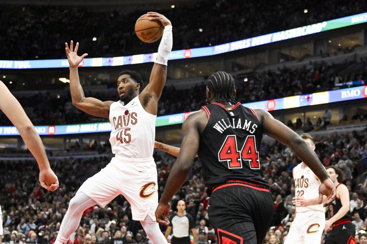Nov 11, 2024; Chicago, Illinois, USA;  Cleveland Cavaliers guard Donovan Mitchell (45) grabs a rebound away from Chicago Bulls forward Patrick Williams (44) during the second half at United Center. Mandatory Credit: Matt Marton-Imagn Images