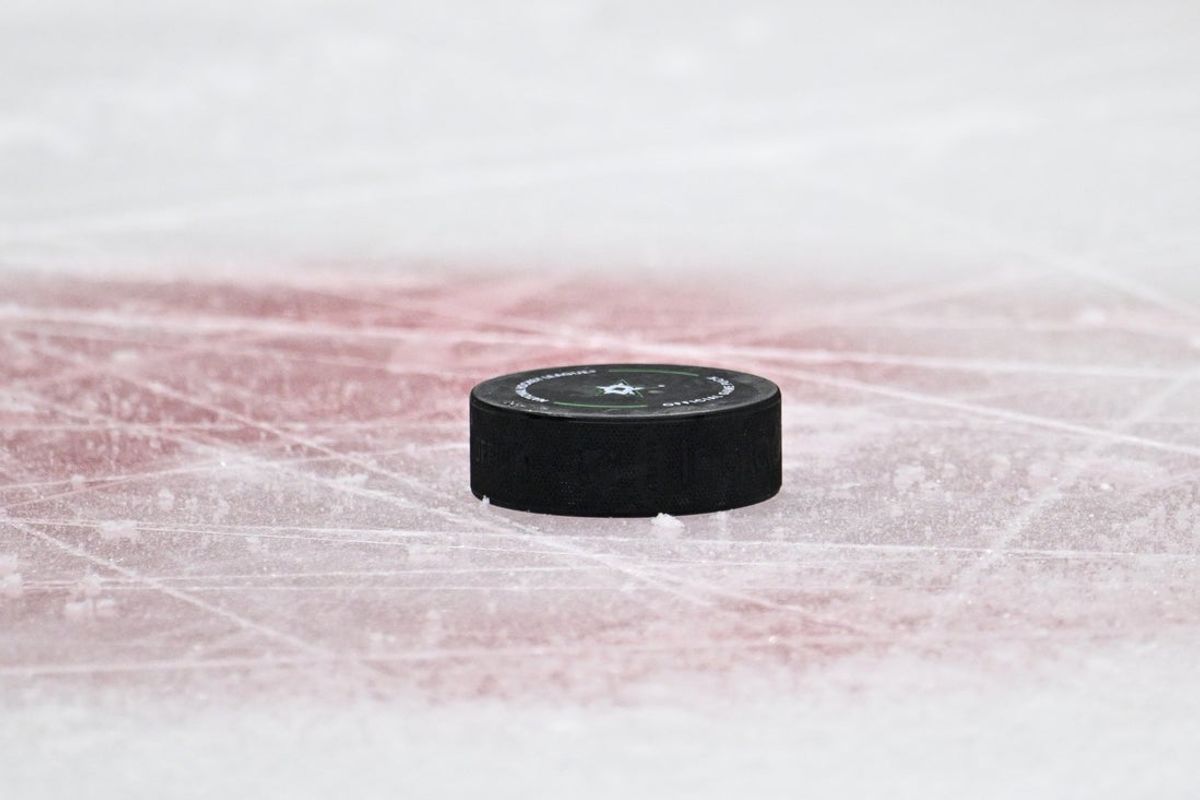 Nov 7, 2024; Dallas, Texas, USA; A view an NHL puck and the Stars logo and the red face-off circle during the game between the Dallas Stars and the Chicago Blackhawks at the American Airlines Center. Mandatory Credit: Jerome Miron-Imagn Images