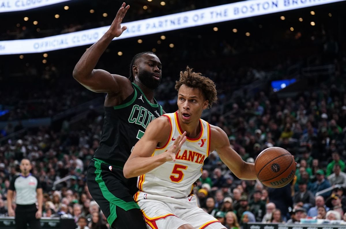 Nov 12, 2024; Boston, Massachusetts, USA; Atlanta Hawks guard Dyson Daniels (5) drives the ball against Boston Celtics guard Jaylen Brown (7) in the first quarter at TD Garden. Mandatory Credit: David Butler II-Imagn Images