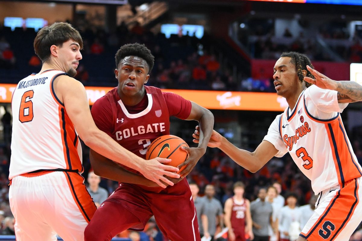 Nov 12, 2024; Syracuse, New York, USA; Colgate Raiders guard Jalen Cox (3) drives between Syracuse Orange forward Petar Majstorovic (6) and guard Lucas Taylor (3) during the first half at the JMA Wireless Dome. Mandatory Credit: Rich Barnes-Imagn Images